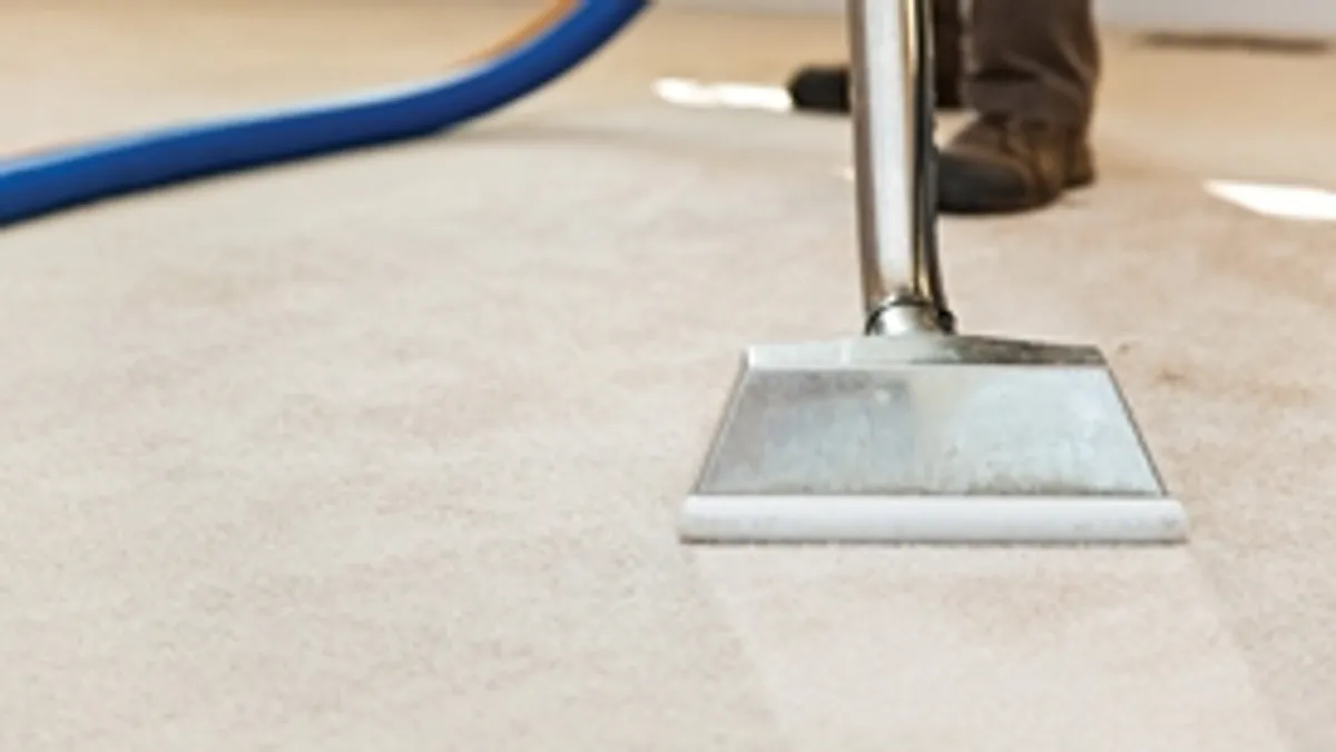 Carpet cleaning wand head gliding over a light carpet during hot-water extraction, Raleigh, NC.